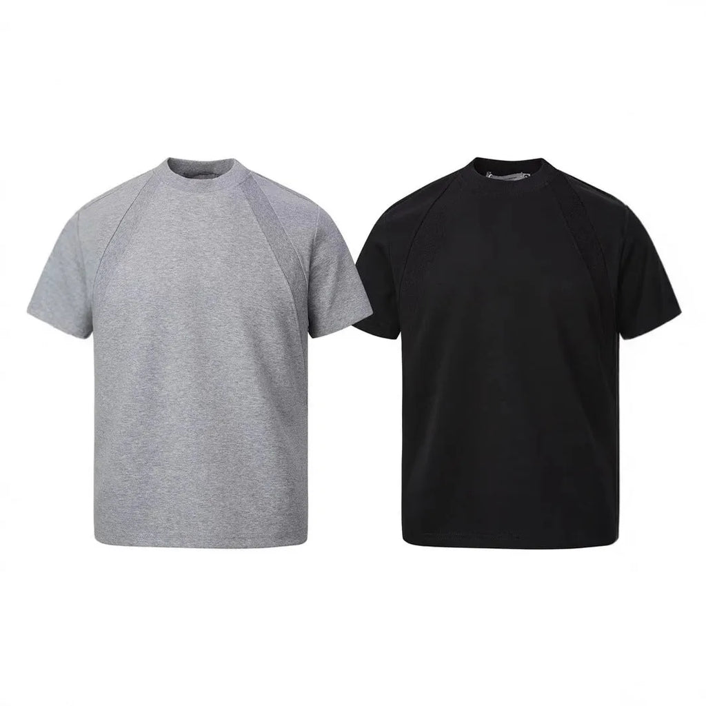 Man wearing a loose-fit grey short-sleeve top with textured air layer stitching detail.
