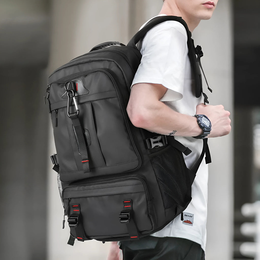 Black oxford cloth large capacity travel backpack with USB port and anti-theft design, showing front view with multiple compartments