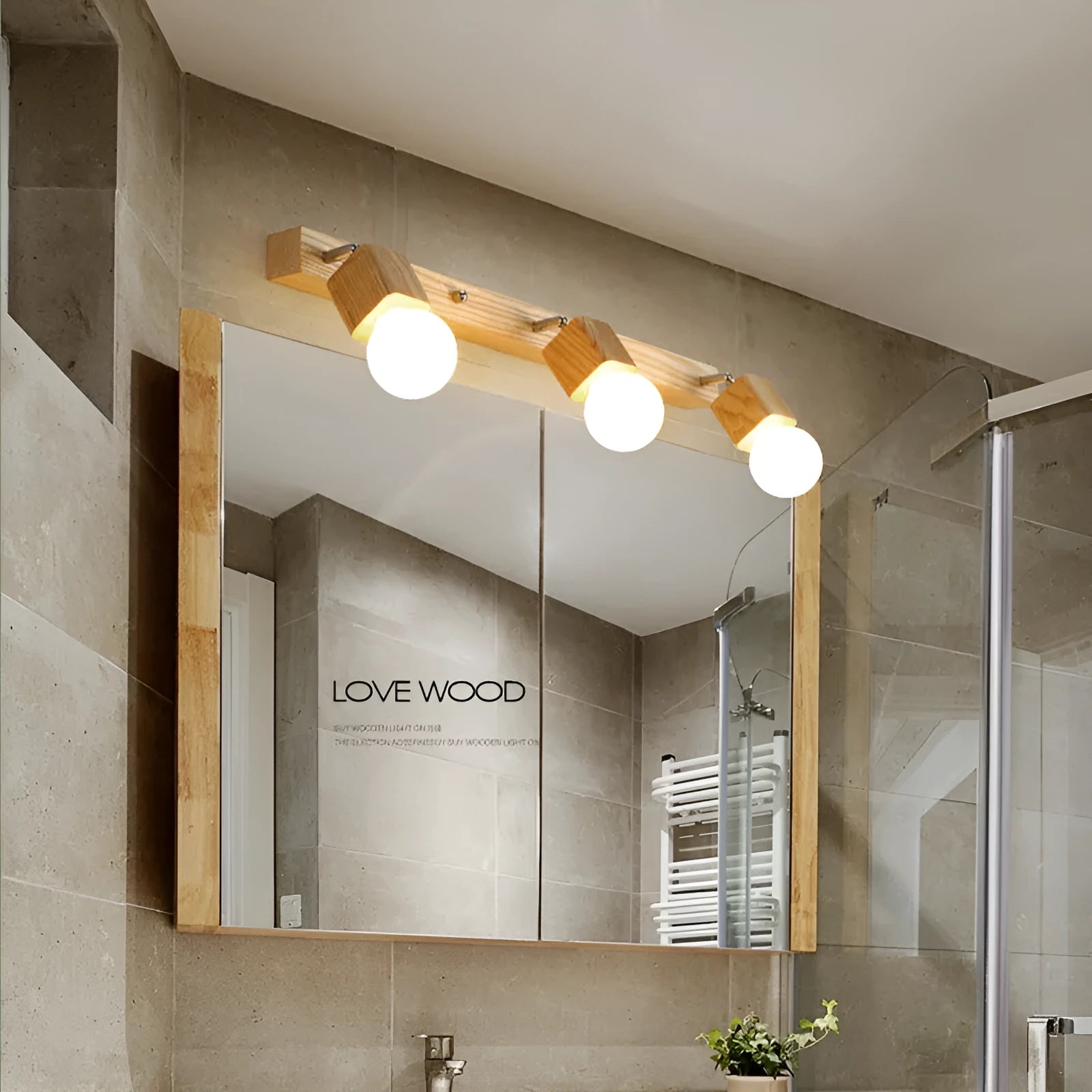 Single head mirror cabinet wall lamp with a 24cm diameter frame.