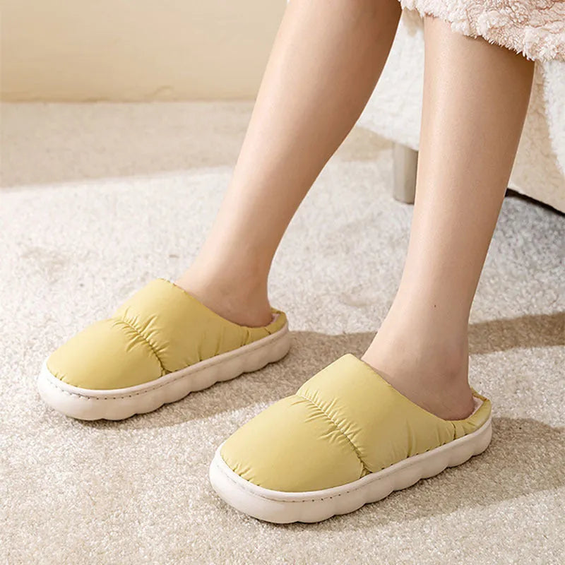 A pair of down cotton indoor slippers with a thick rubber sole and plush lining, shown in a choice of colours.