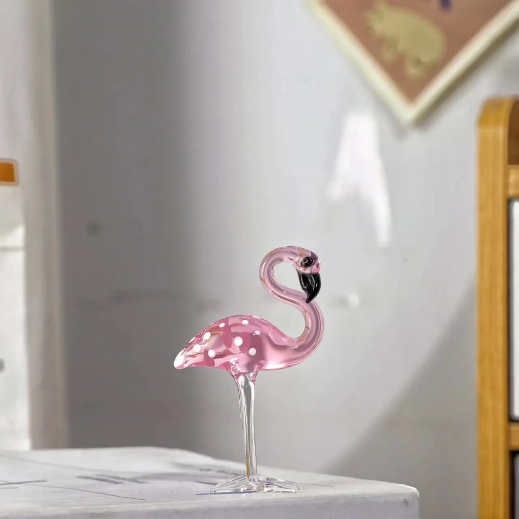 Pink crystal flamingo decorative figure on a table in modern style.