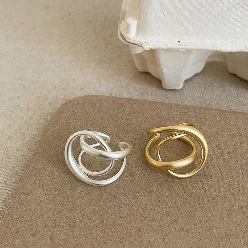 Geometric interlaced matte metal open ring for women in gold or silver colour.
