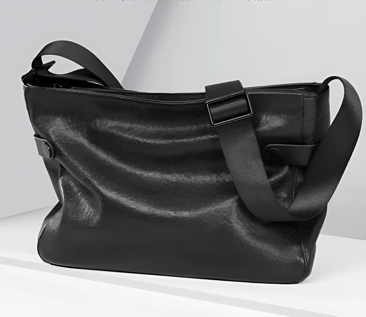 Men's black genuine leather and cowhide crossbody messenger bag with waterproof function and patchwork detail.