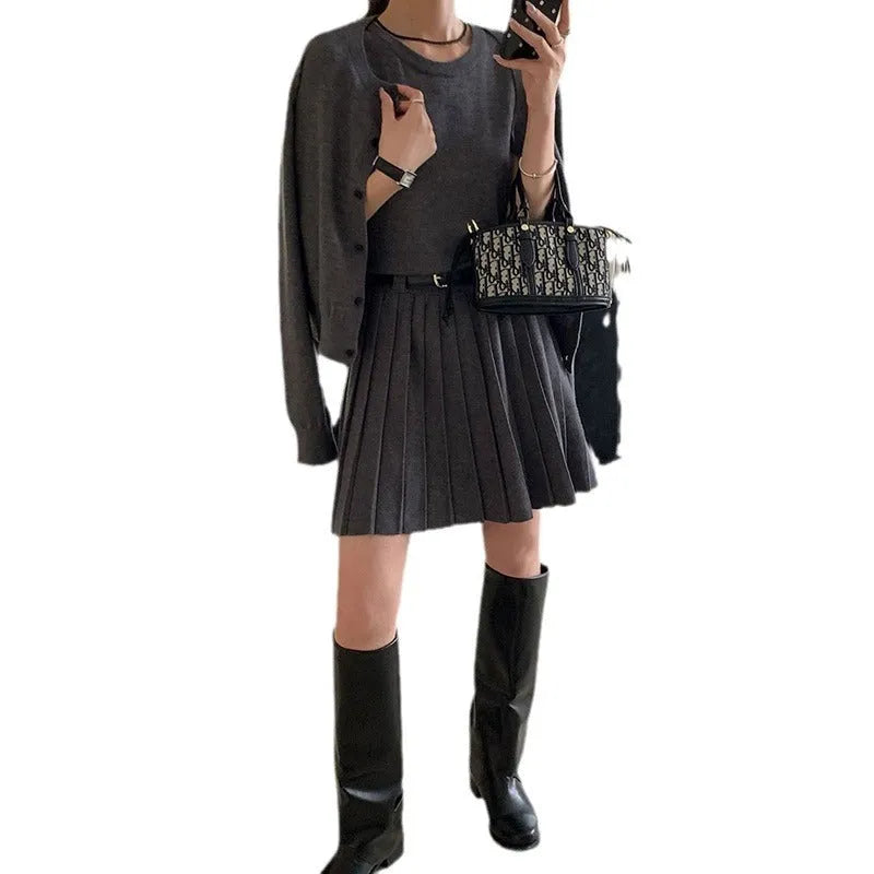 Women's grey art retro two-piece set with pleated vest skirt, adjustable belt, and long-sleeved knitted cardigan.