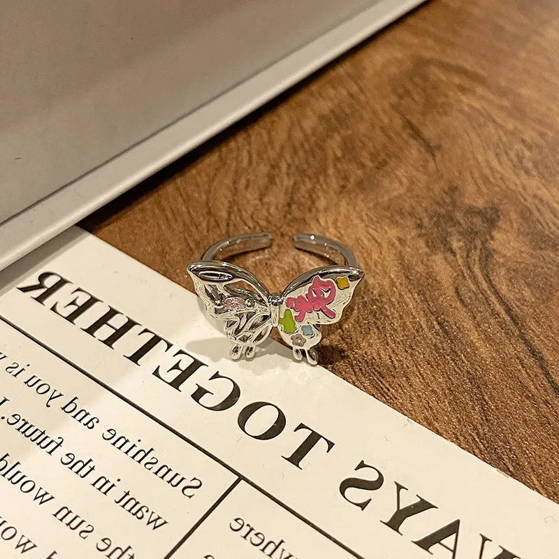 Copper butterfly women's ring with dripping oil texture and an open loop design.