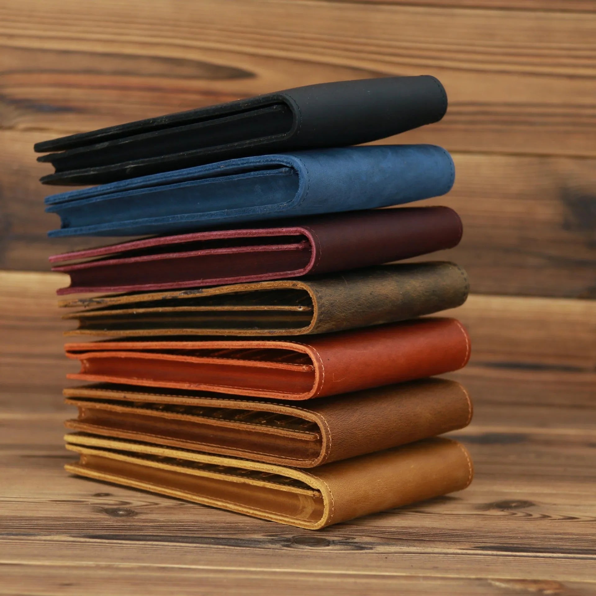 Slim brown cowhide men's wallet open to show 18 card slots and a phone compartment.