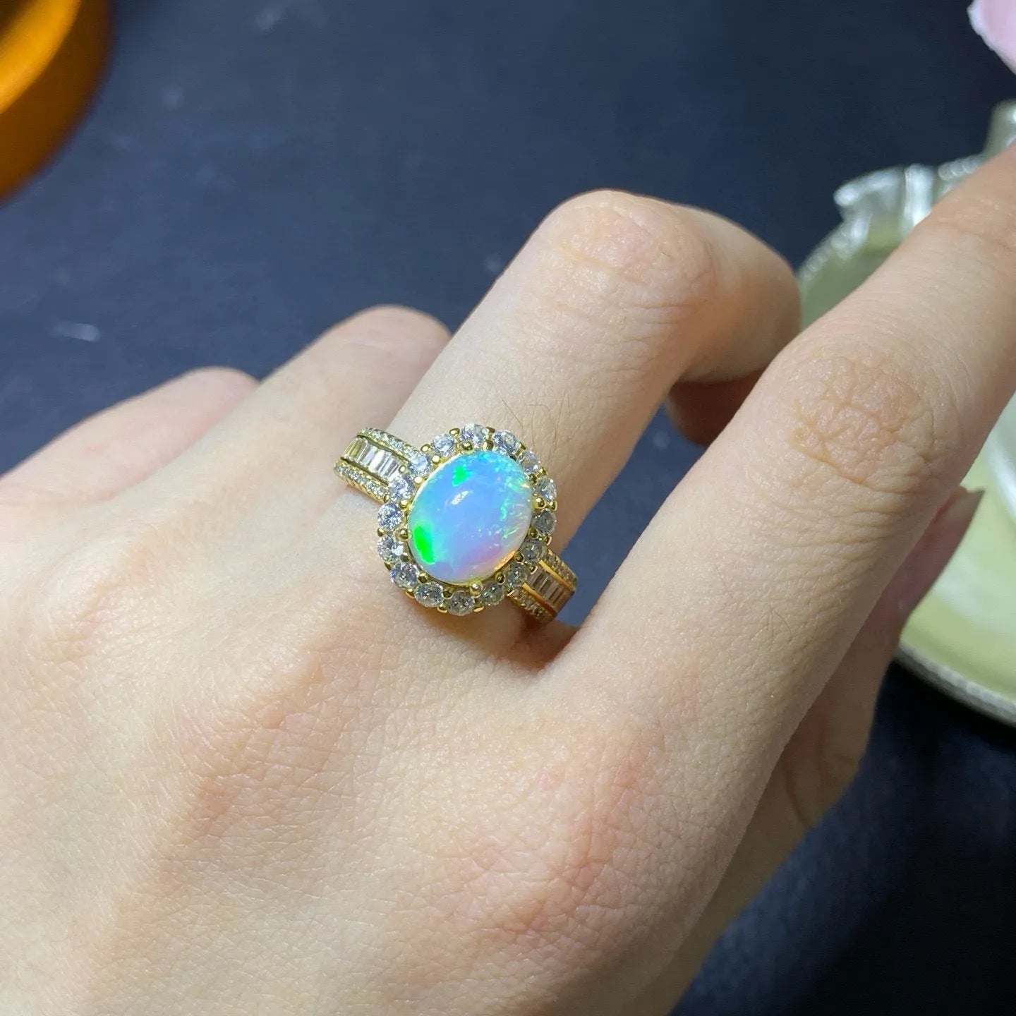 Handmade women's silver opal ring with an opening design, shown in a choice of colour plating.