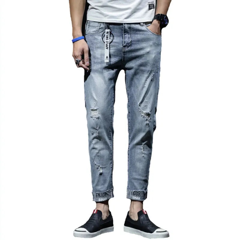 Light blue ripped jeans with straight leg, mid waist, and cropped length for youth
