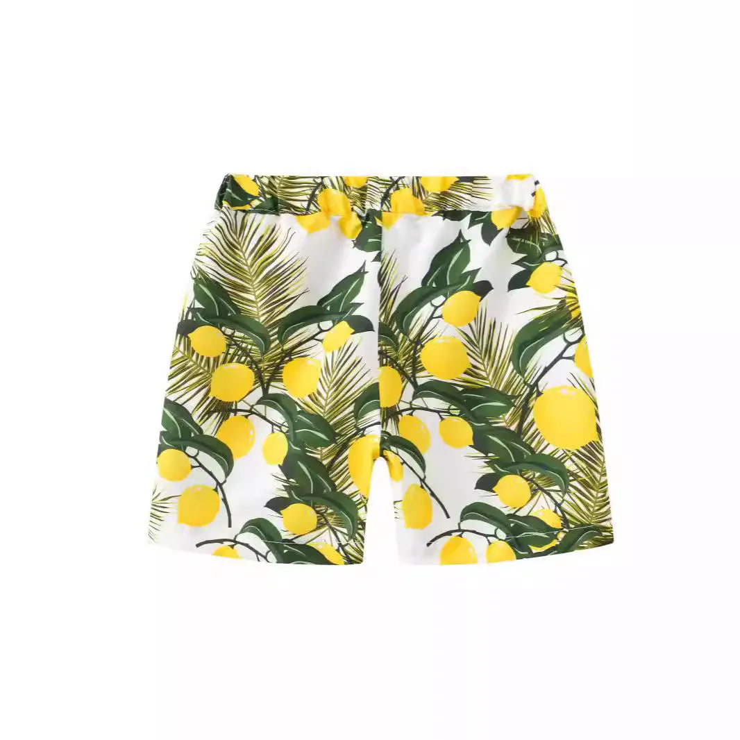 Children's elastic waist beach shorts with colourful coconut tree print, shown in shorts length.