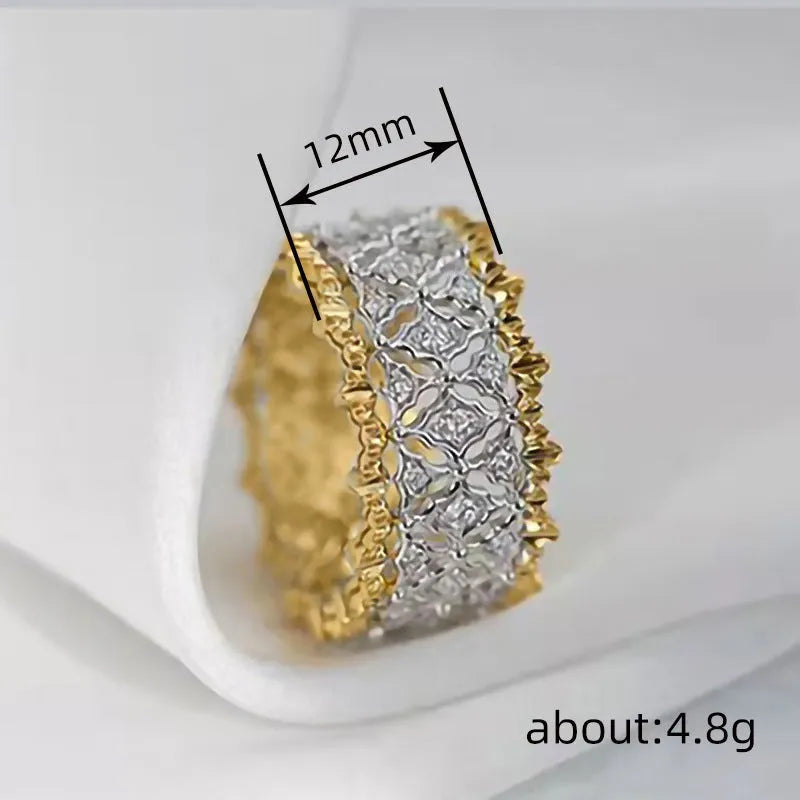 Geometric two-tone copper ring with a round zircon stone, shown on a hand.