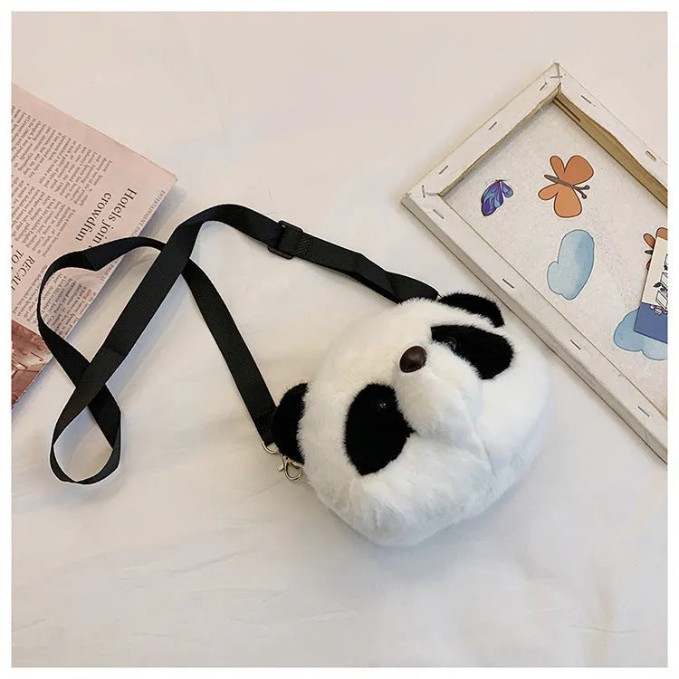 Soft plush crossbody bag with panda head design, cylindrical shape.