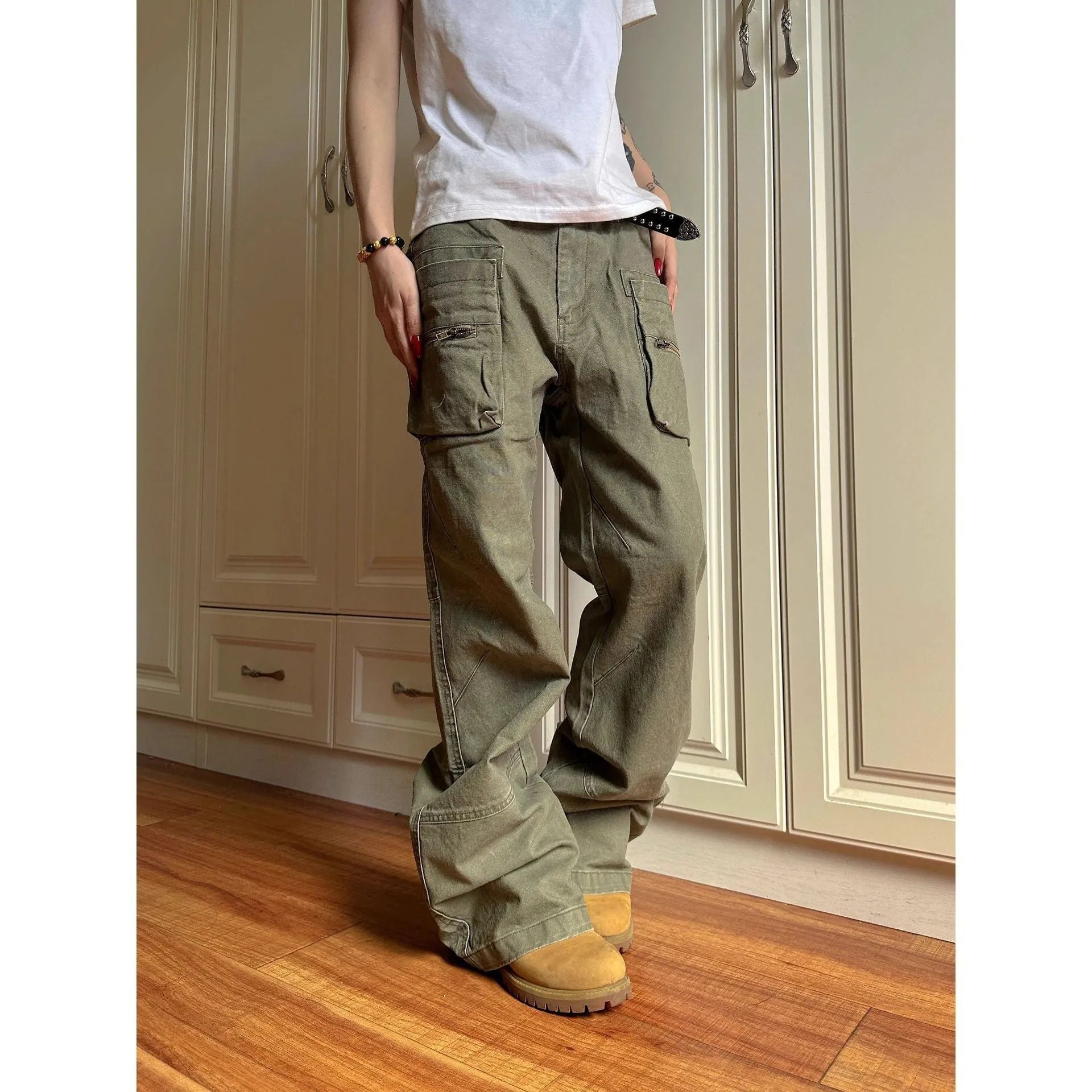 Green and black double zipper casual cotton pants with an elasticated waistband on a hanger.