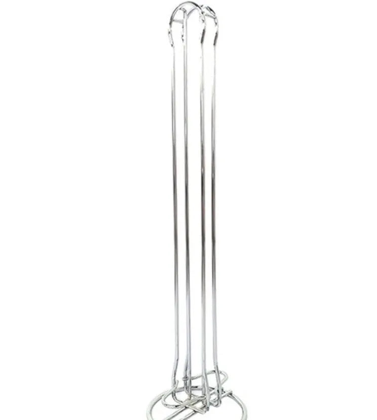 Black wrought iron coffee capsule storage rack holding pods on a kitchen counter.