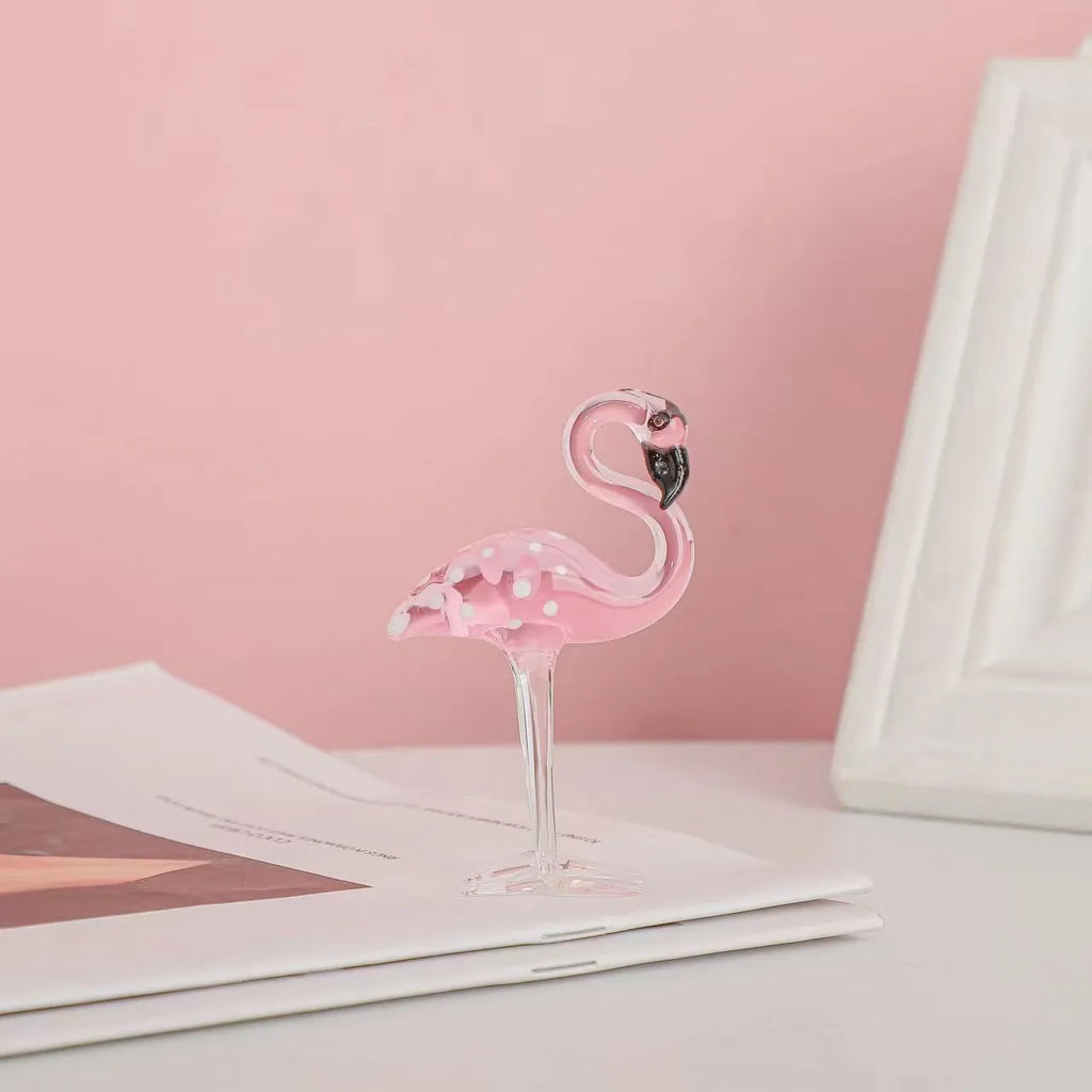 Pink crystal flamingo decorative figure on a table in modern style.