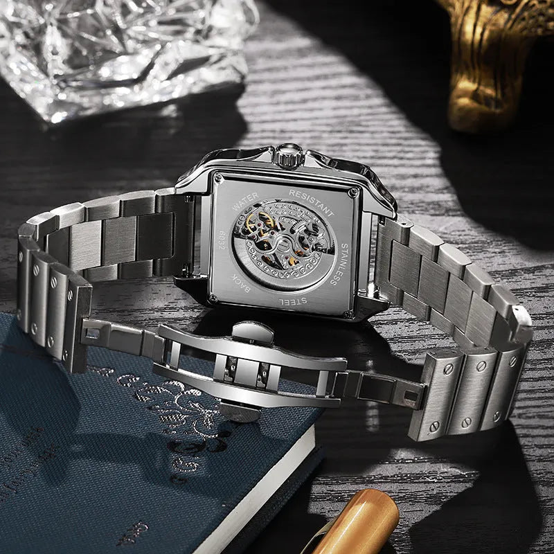 Men's square automatic watch with diamond studs on a black steel strap.