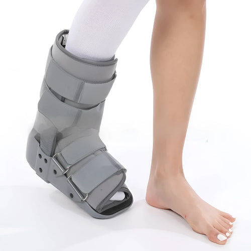 Black Achilles tendon rehabilitation boot with aluminium uprights on a grey background.