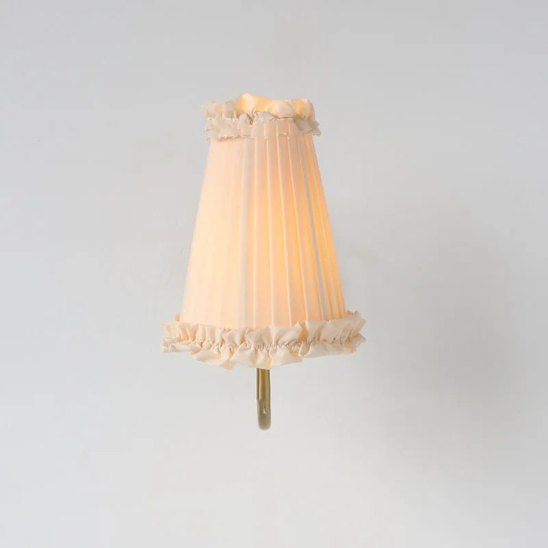 Wheat wall lamp with fabric shade and iron frame mounted on a bedroom wall with warm non-stroboscopic light