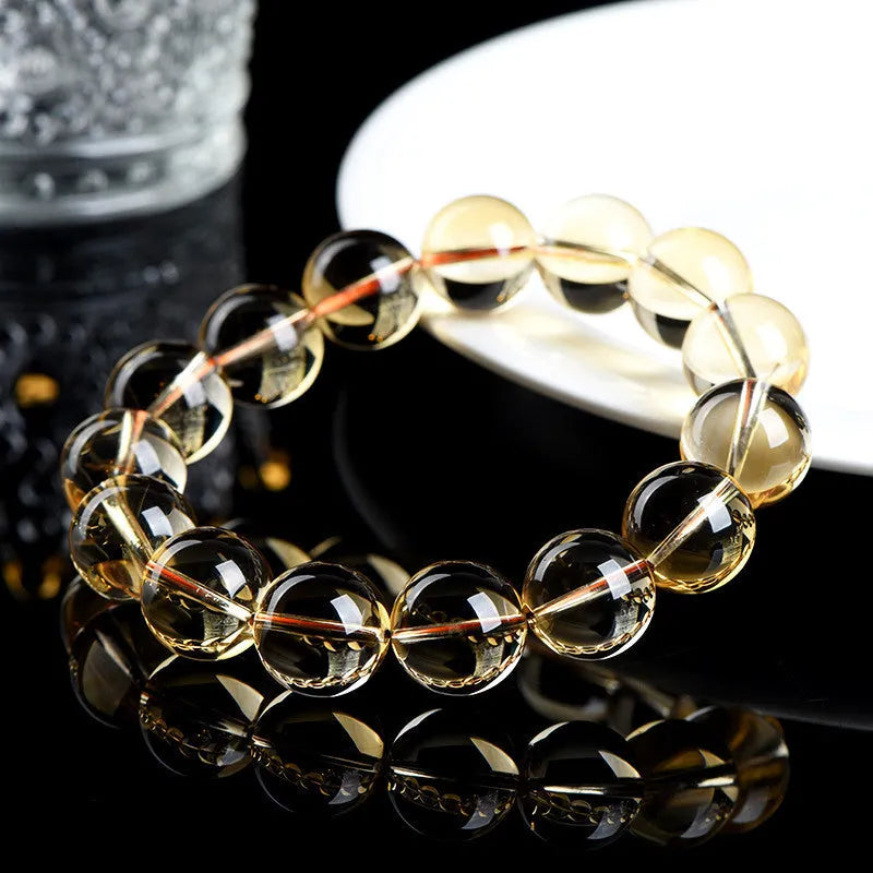 Original design natural citrine scattered bead bracelet on a wrist, showing polished stones in a golden hue.