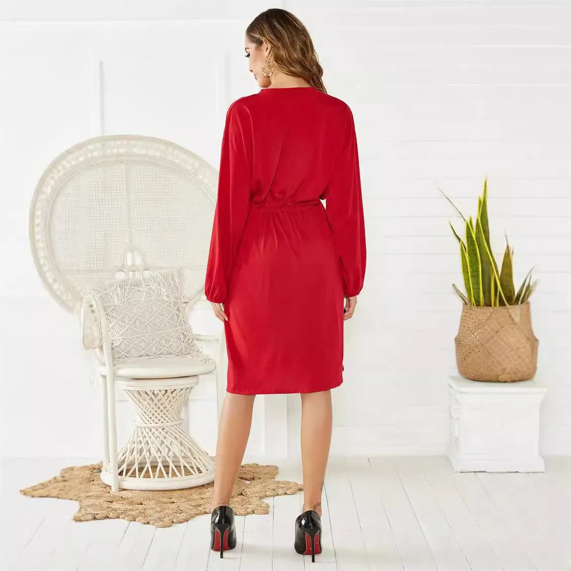 Black mid-length A-line dress with long sleeves and an elastic cinched waist with a loose belt.
