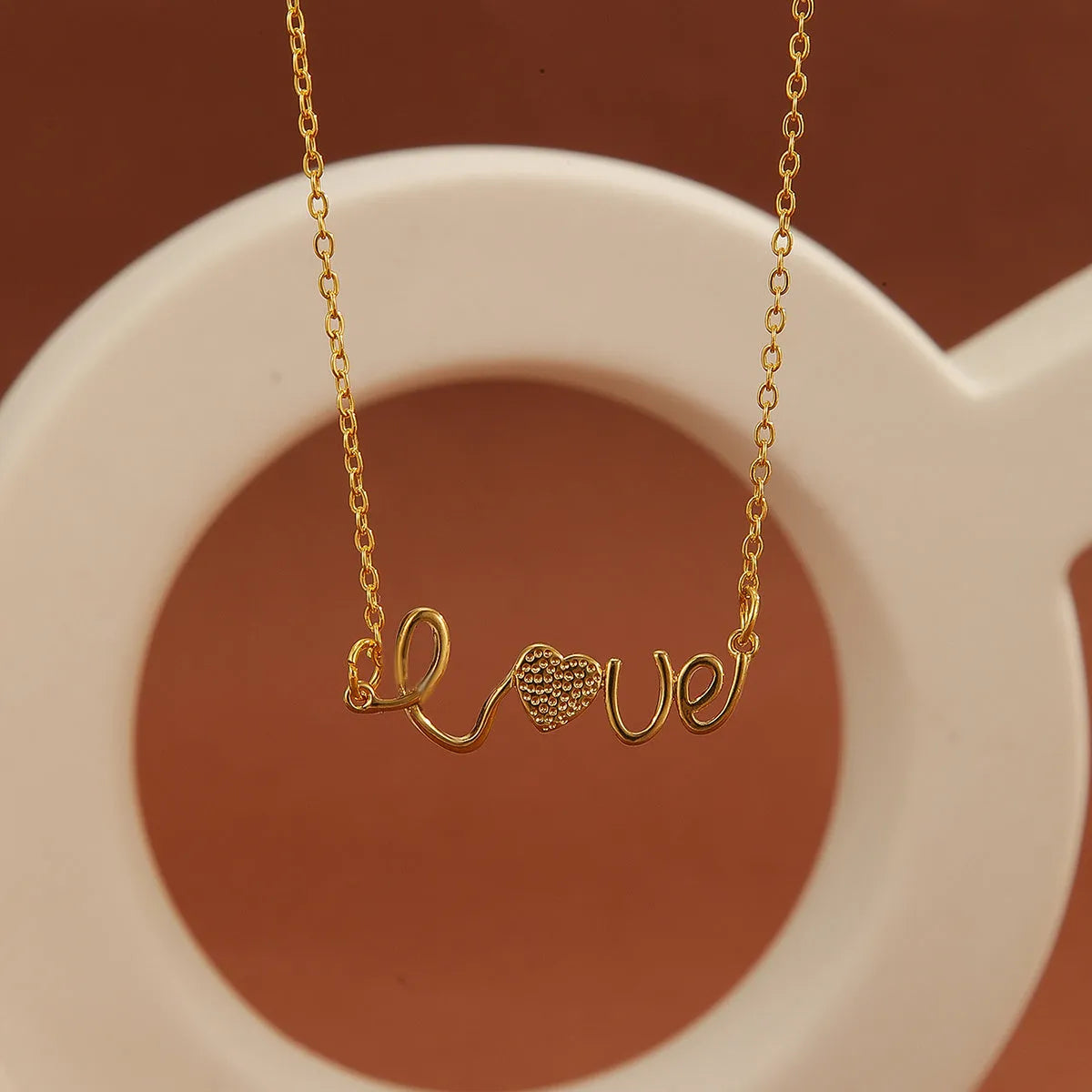 Gold plated copper infinity love pendant necklace with diamond accents and fine chain.