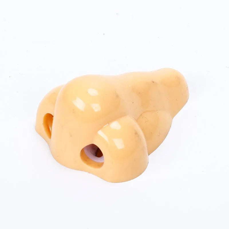 Flesh colour plastic manual pencil sharpener with big nostril, showing geometry shape.