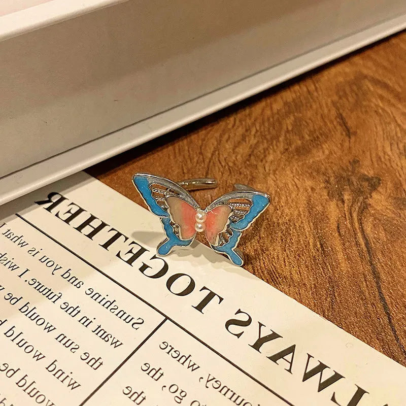 Copper butterfly women's ring with dripping oil texture and an open loop design.