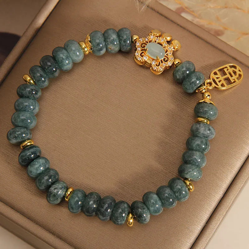 Women's bracelet with green jade abacus beads and a metallic safety lock clasp.