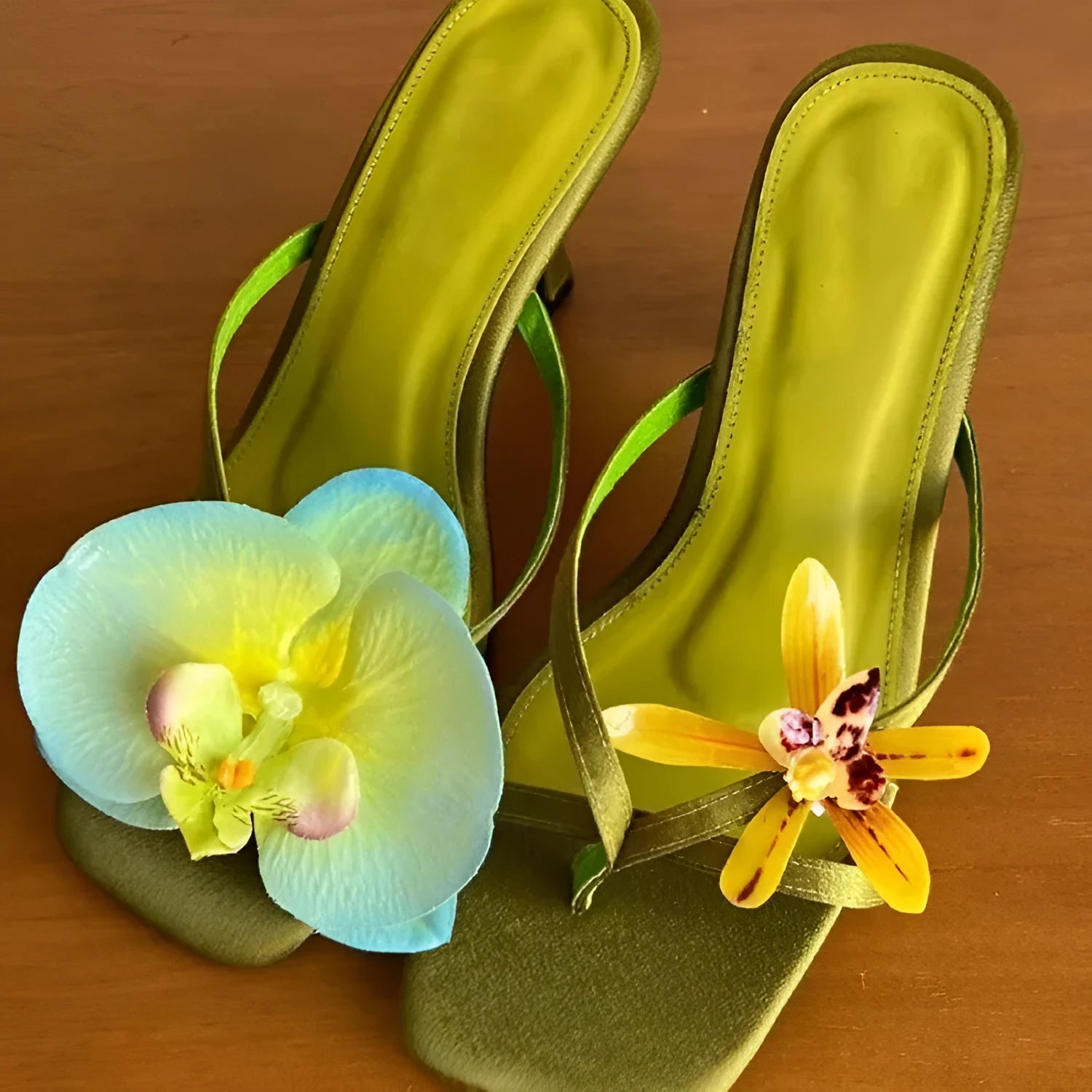 Handmade women's asymmetric flower sandals with high heel and square toe in black leather.