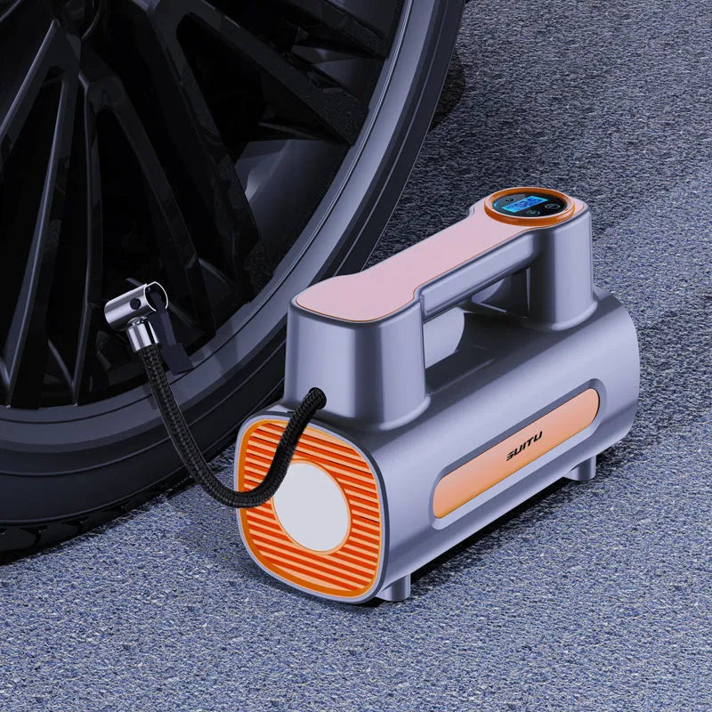 Black portable car tyre inflator with digital LCD screen and USB charging cable on a grey background