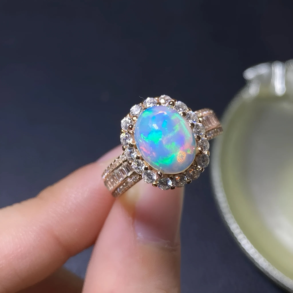 Handmade women's silver opal ring with an opening design, shown in a choice of colour plating.
