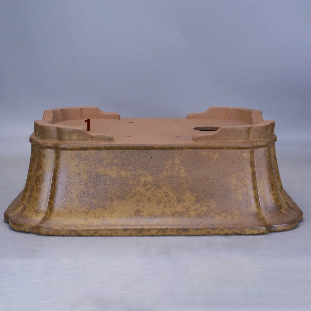 A large, modern rectangular purple sand ceramic flowerpot with sharp angles, shown on a patio.