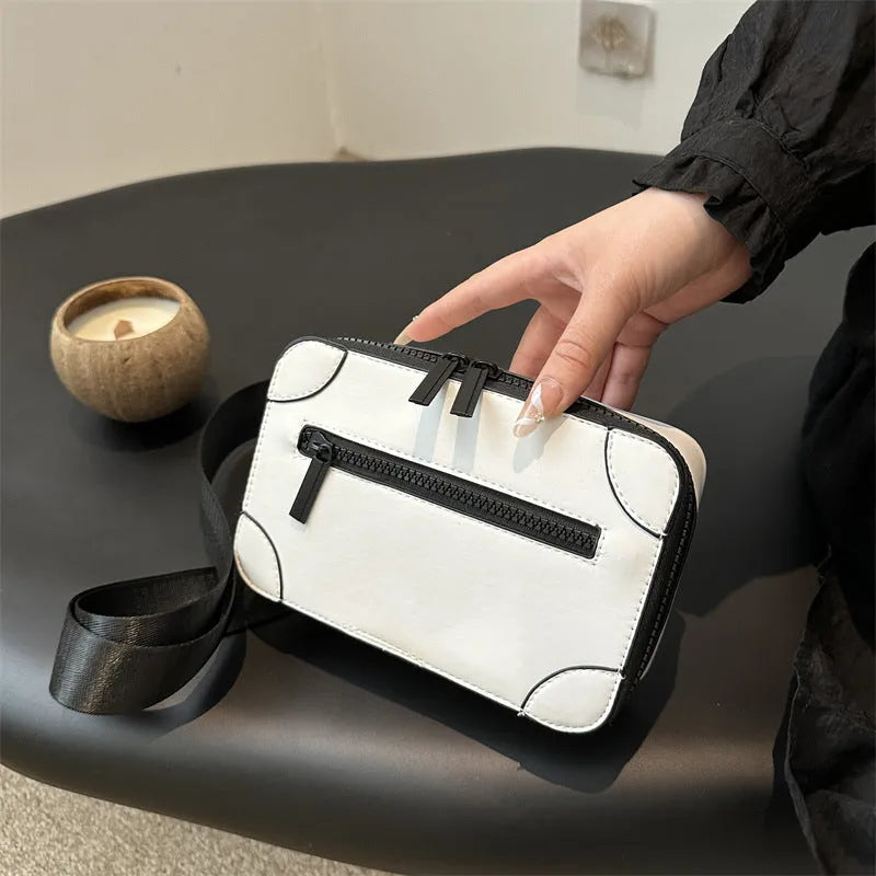 Women's black PU leather square crossbody bag with adjustable strap and outer pocket.