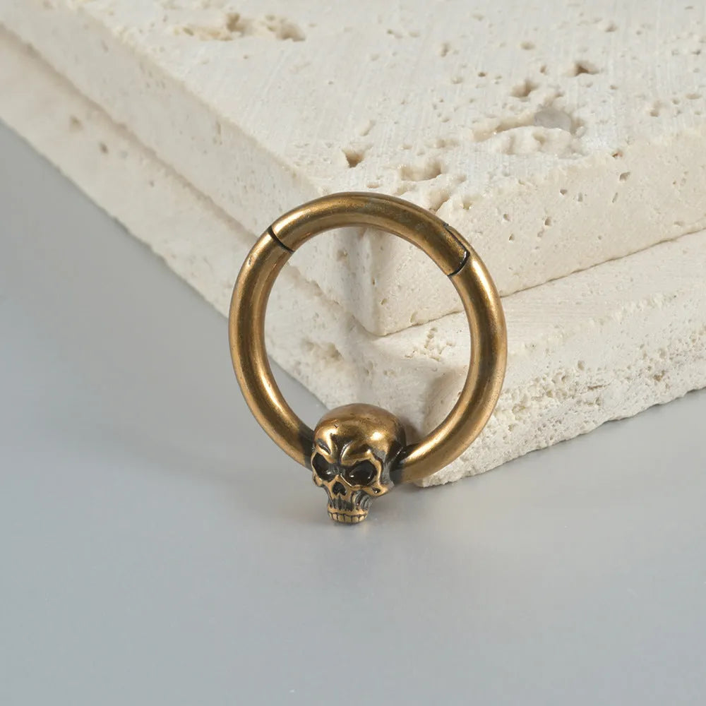 Copper punk earrings with ghost head design in antique gold or silver finish.