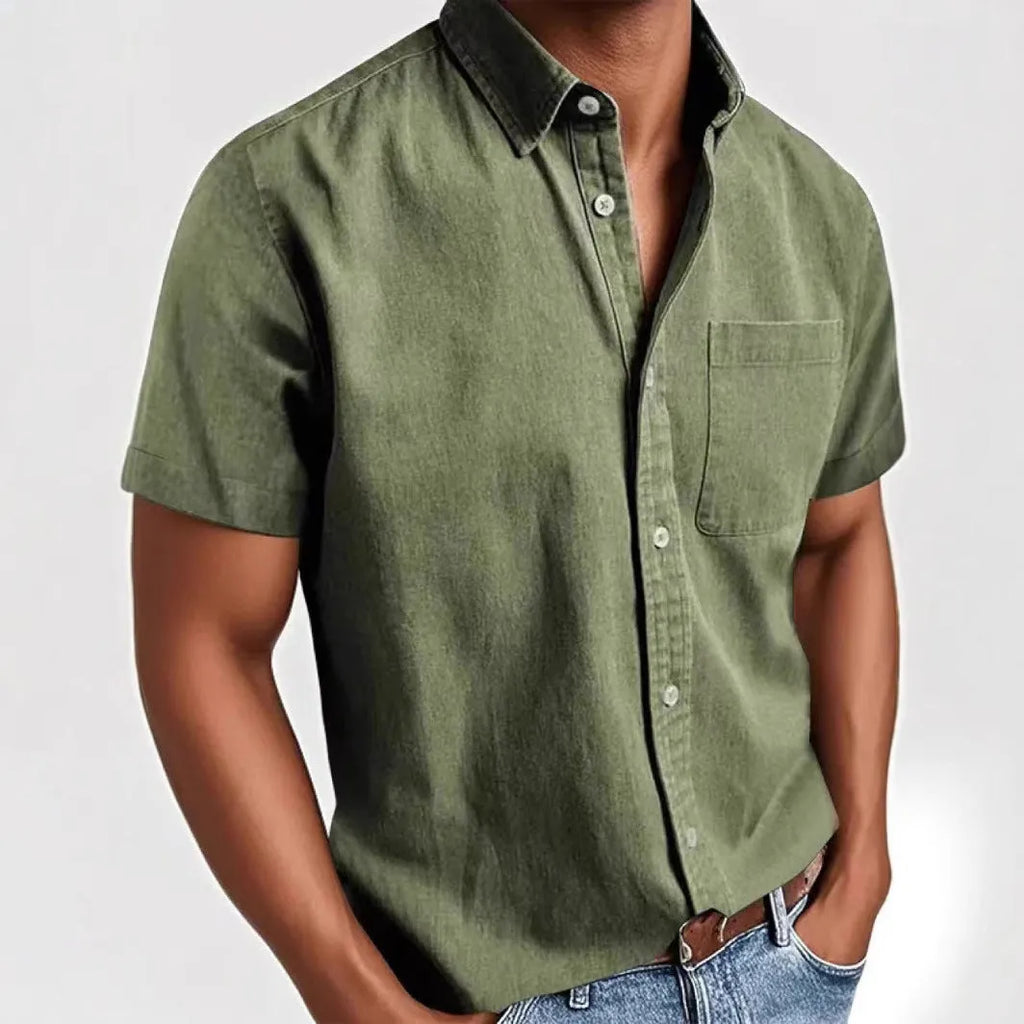 Man wearing a loose-fit grey short sleeve casual shirt with a single-breasted, cardigan-style design.