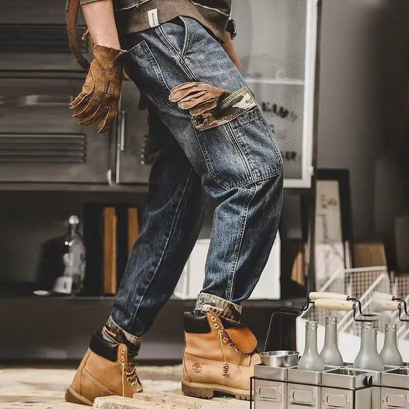 Men's loose blue denim cargo jeans with heavy distressed finish, mid waist, button fly