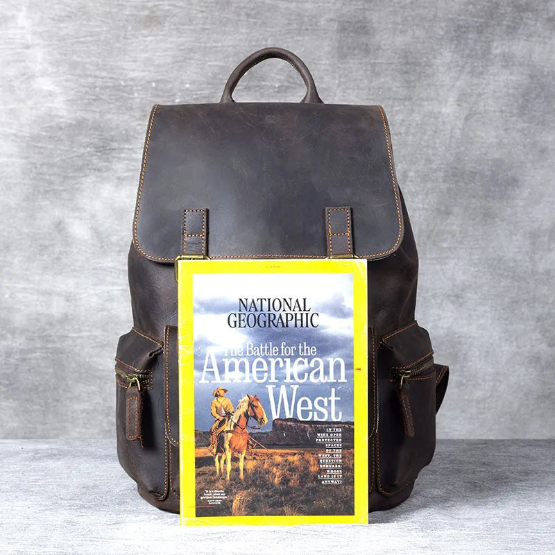 Brown leather backpack with double shoulder straps and denim lining interior