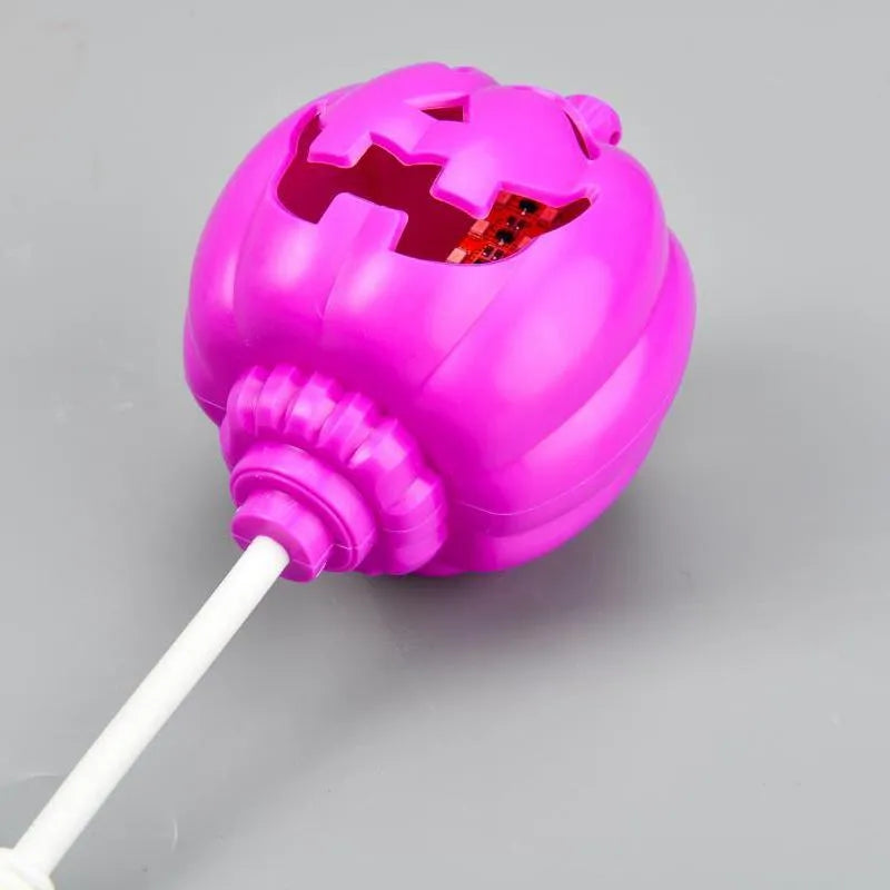 Plastic pumpkin lamp with USB charging cable showing yellow and purple light options