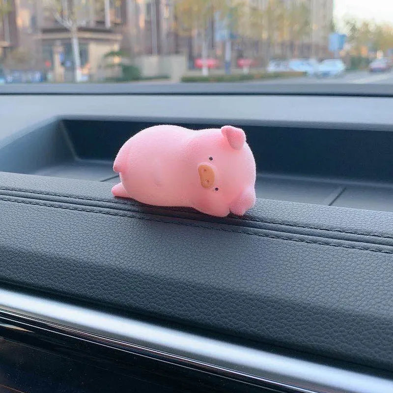Glossy resin cartoon pig ornament for car dashboard decoration, shown in one of eight available character styles.