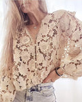 Loose-fit black lace cardigan with 3D flower detailing on a model, showing V-neck and long sleeves.