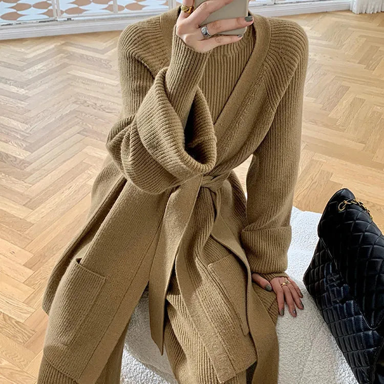 Women's apricot knitted three-piece set showing V-neck top, wide-leg trousers, and longline cardigan with leather stitching detail.