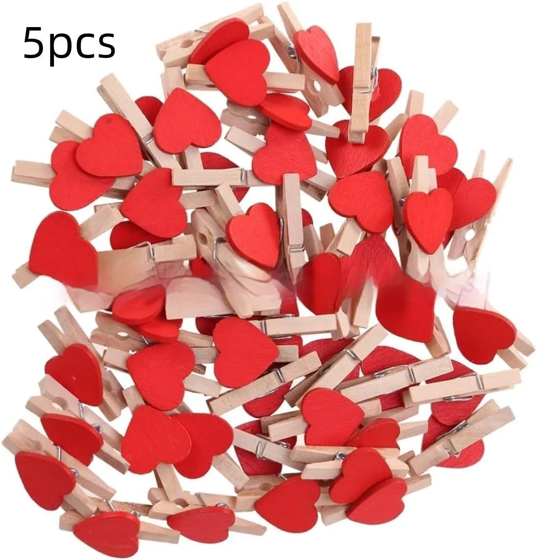 Five handmade wooden heart-shaped clips in red, pink, white, and yellow colours on a table.
