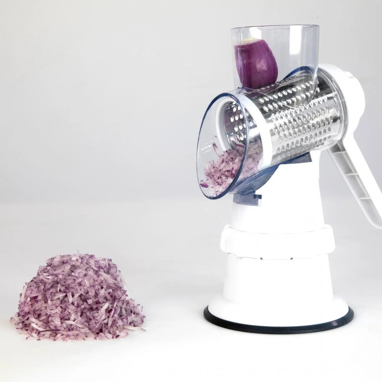 White plastic manual vegetable slicer with rotating drum and suction feet