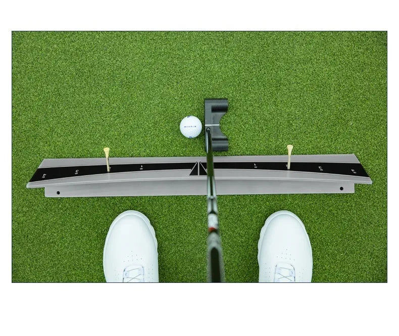 Golf putter with attached adjustable balance simulator showing the extended push rod mechanism on a putting mat.