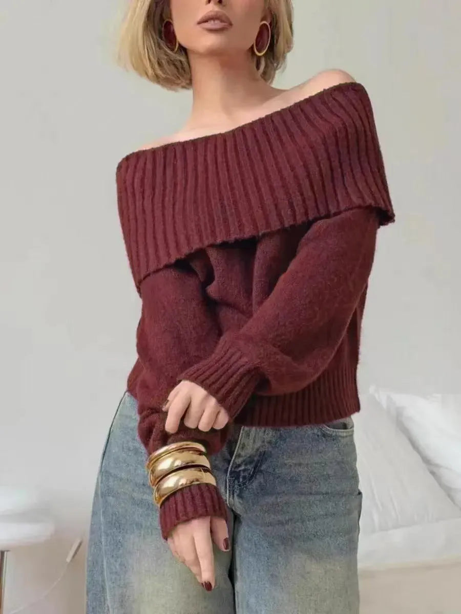 Grey off-the-shoulder women's sweater with a 3D knit pattern and strapless neckline on a hanger.