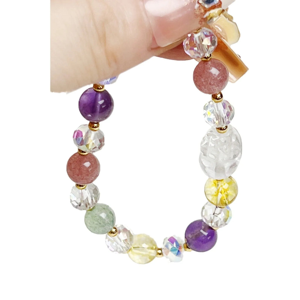 Close-up of a manually crafted crystal bracelet with a nine-tail fox centrepiece on a wrist.