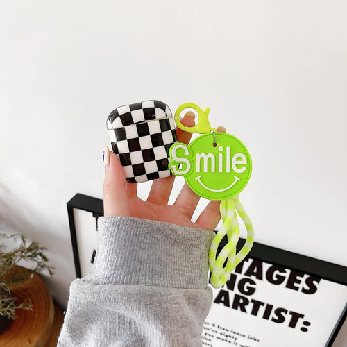 Black and green checkerboard patterned TPU protective case for Apple AirPods with optional lanyard and loop pendant attachments.