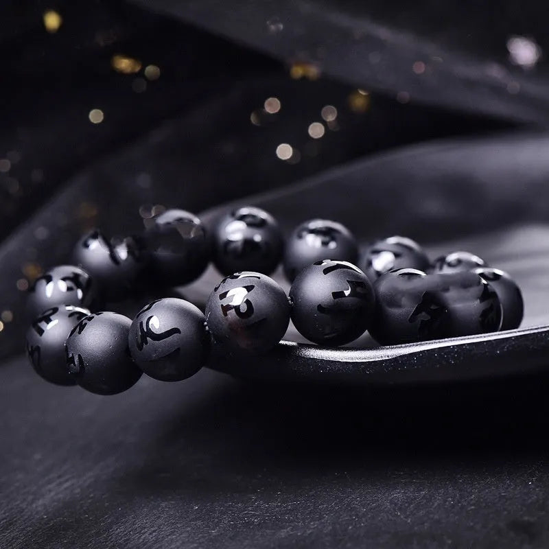 Natural frosted black agate Sanskrit mantra bracelet with Chinese auspicious patterns on beads.
