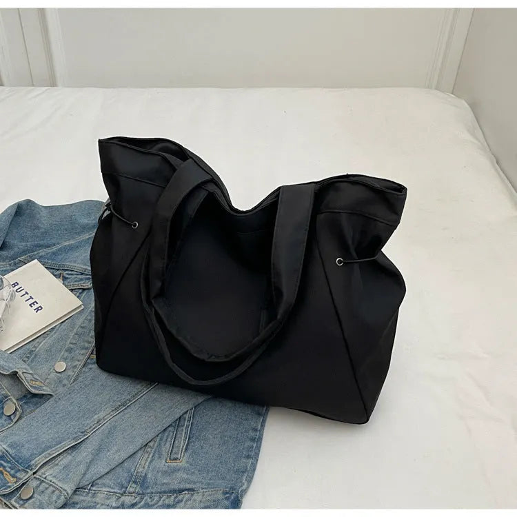 Soft Oxford cloth folding tote bag in five colour options showing shoulder carry design