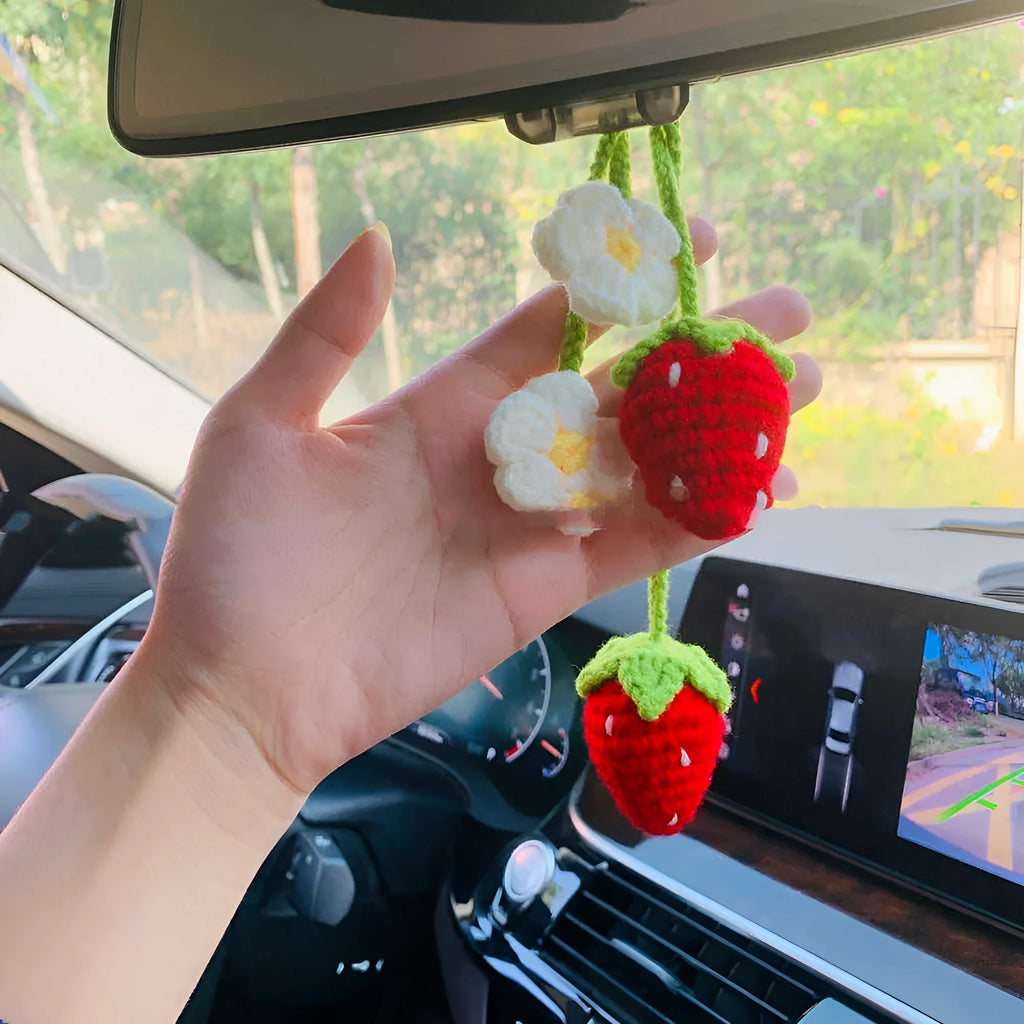 Handmade knitted strawberry-shaped car pendant made from cotton and hemp wool.