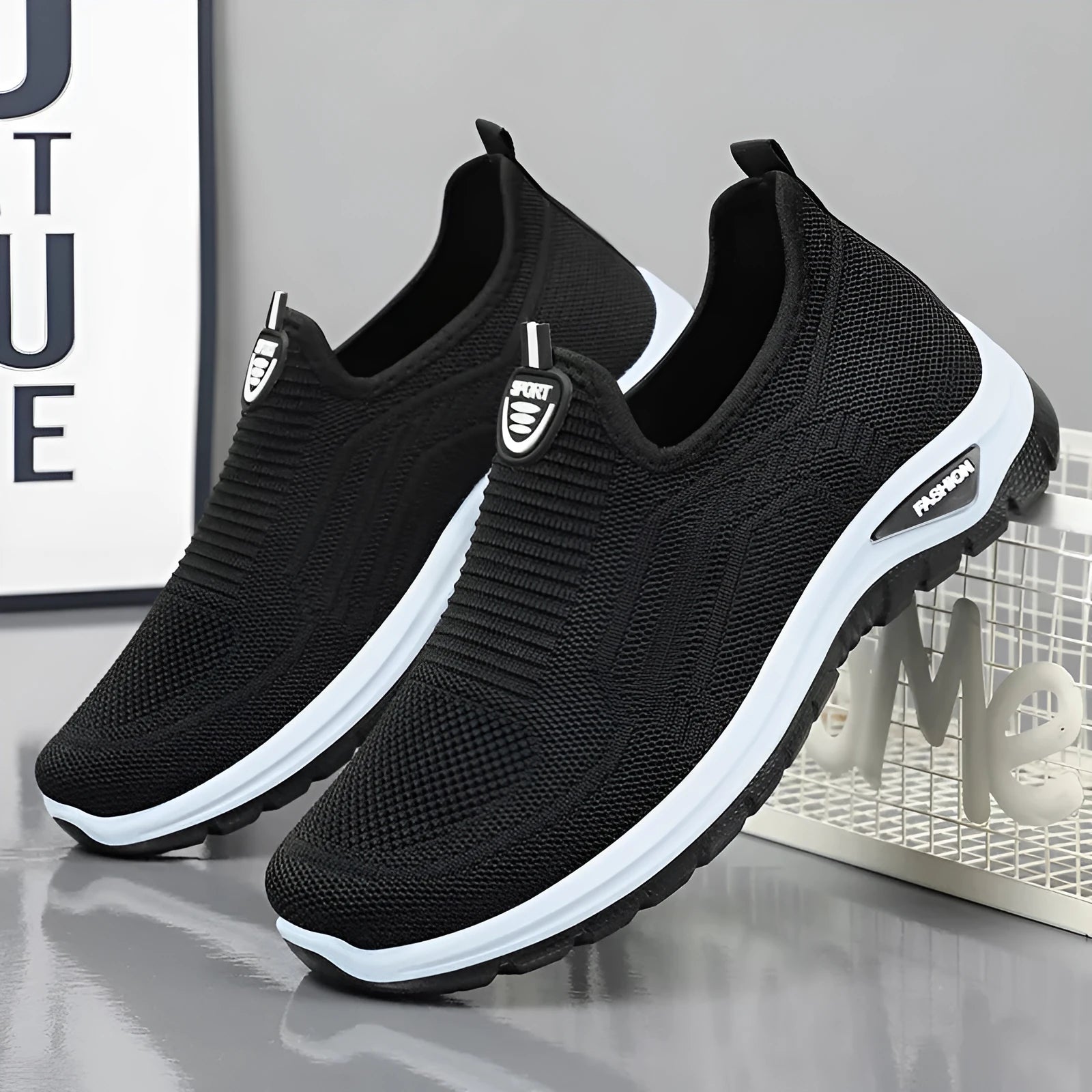 Men's black and grey breathable casual tennis shoes with mesh upper and round toe.